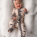 Ruffled Bamboo Zippy Sleeper in Lana (Bows)